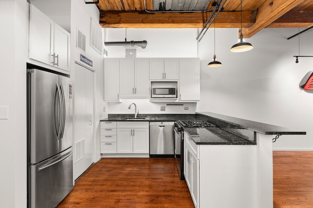 kitchen with visible vents, beam ceiling, a sink, appliances with stainless steel finishes, and a peninsula