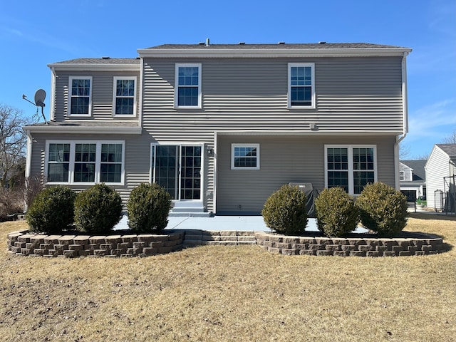 rear view of property with a lawn