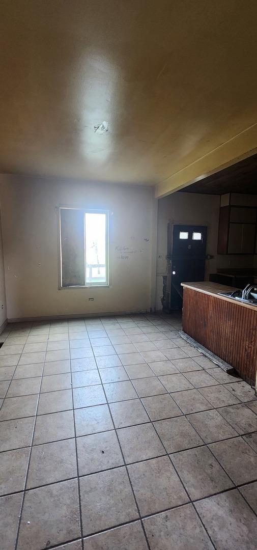 245 153rd Pl, Calumet City, IL 60409 - spare room featuring light tile patterned floors