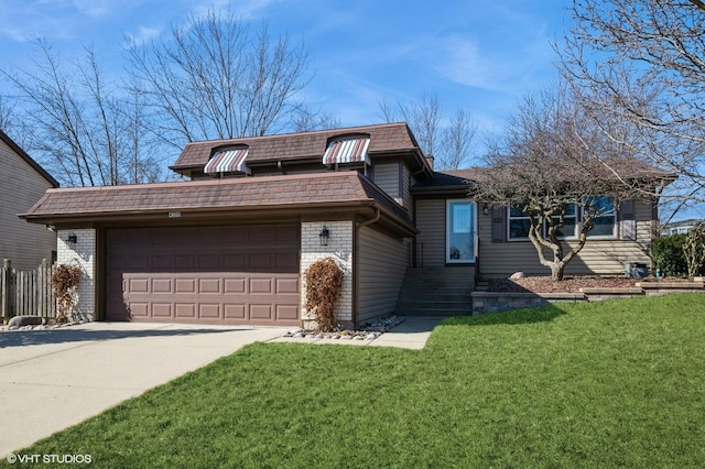 split level home featuring mansard roof, concrete driveway, an attached garage, a front yard, and brick siding