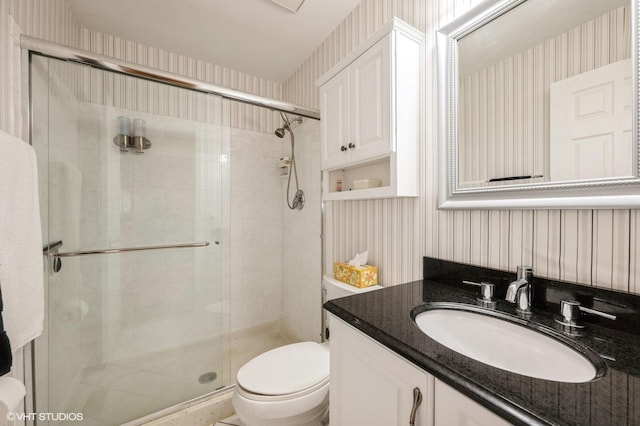 full bath featuring toilet, a stall shower, and wallpapered walls