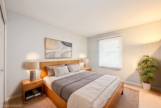 bedroom featuring carpet and baseboards