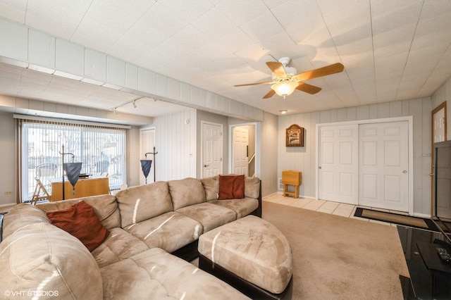 living room featuring rail lighting, carpet flooring, and ceiling fan