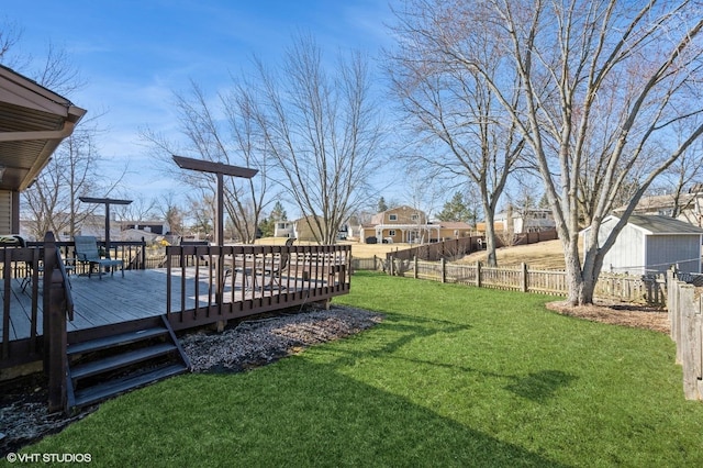 view of yard featuring a wooden deck and fence