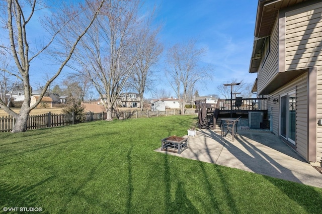 view of yard with a fenced backyard, an outdoor fire pit, stairs, and a deck