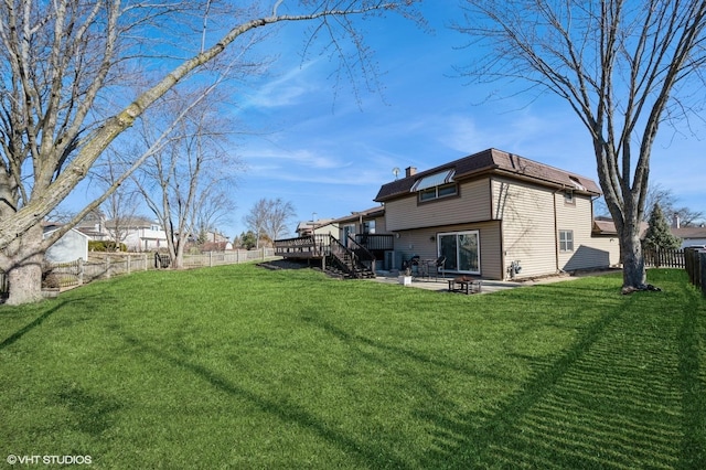 view of yard featuring a patio area, a deck, and a fenced backyard