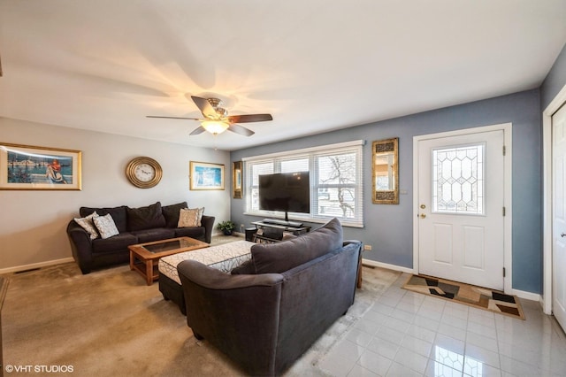 living area with visible vents, baseboards, and a ceiling fan