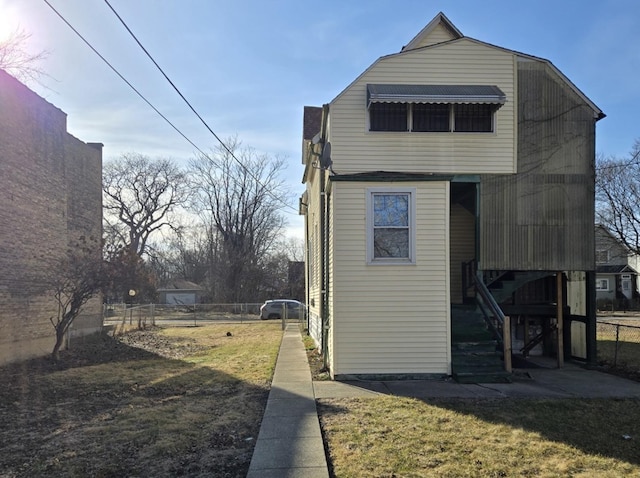 view of side of property with a yard and fence