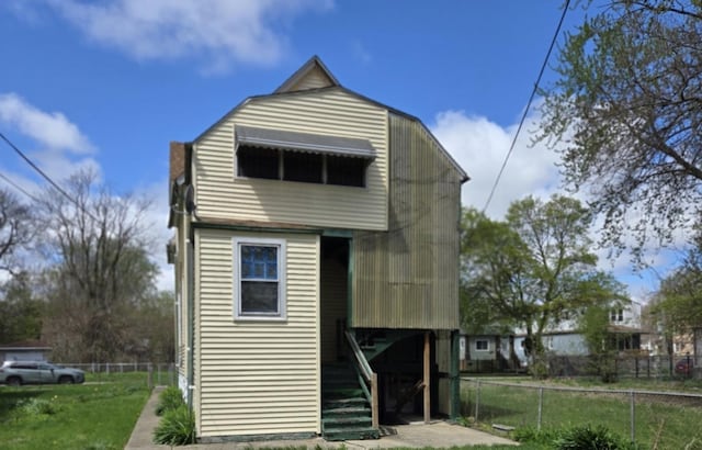 11733 S Stewart Ave, Chicago, IL 60628 - rear view of property with fence, stairway, and a yard