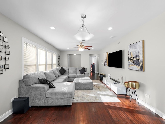 living area with a ceiling fan, recessed lighting, wood finished floors, and baseboards