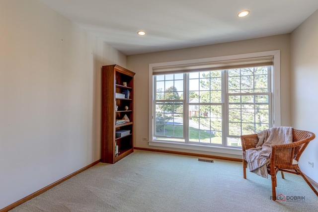 sitting room with light carpet, visible vents, recessed lighting, and baseboards