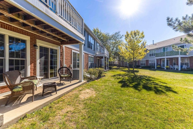 view of yard with a balcony and a patio area