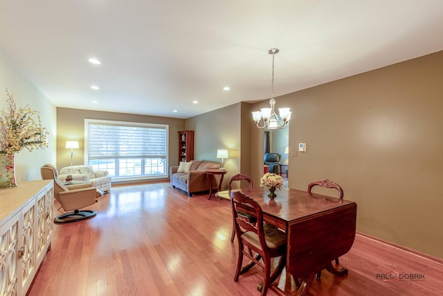 dining space with a notable chandelier, recessed lighting, and light wood-type flooring