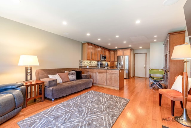 living area featuring recessed lighting and light wood-style flooring