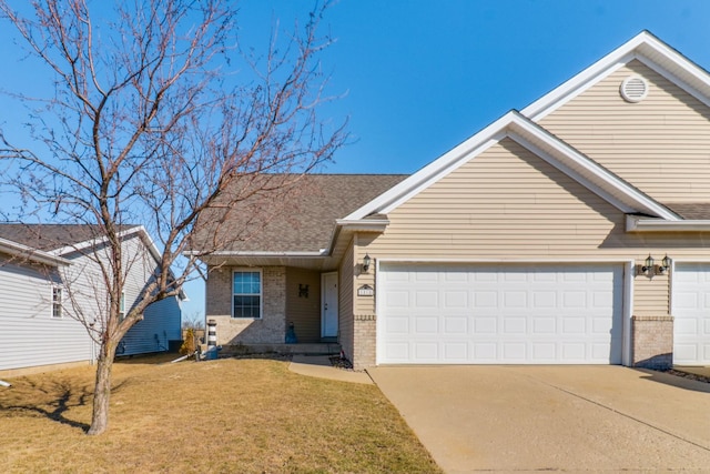 ranch-style house with driveway, a front yard, a shingled roof, a garage, and brick siding