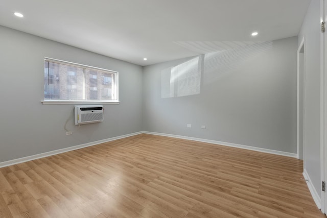 spare room with recessed lighting, baseboards, and light wood-style floors