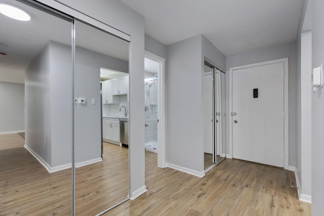 entrance foyer with light wood-type flooring and baseboards