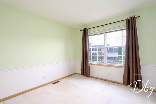 unfurnished room with visible vents, carpet flooring, and baseboards