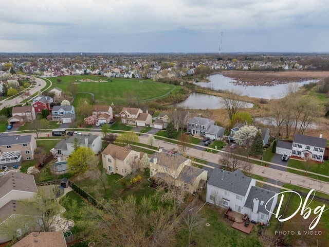 drone / aerial view with a water view and a residential view