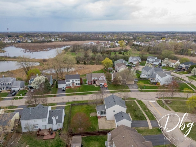 bird's eye view with a residential view and a water view
