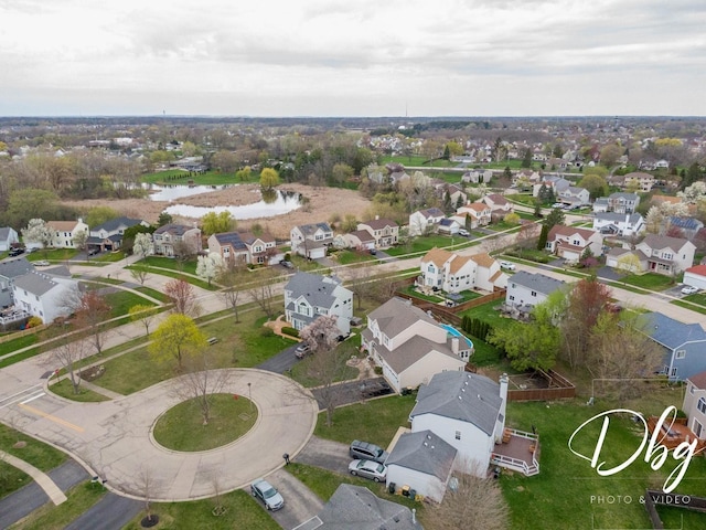 birds eye view of property with a water view and a residential view