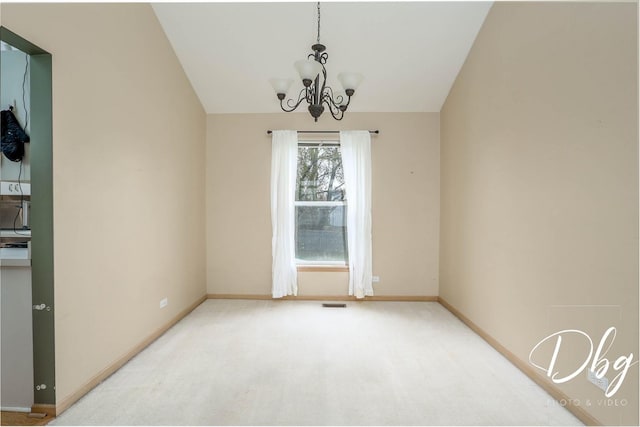empty room featuring carpet flooring, a notable chandelier, baseboards, lofted ceiling, and visible vents