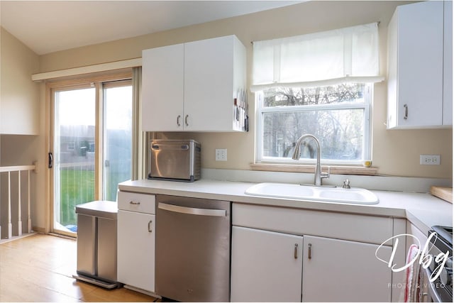 kitchen featuring light countertops, white cabinetry, a sink, and dishwasher