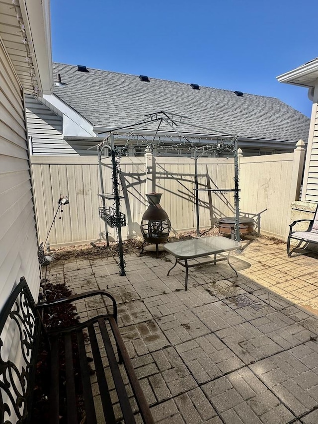 view of patio featuring fence