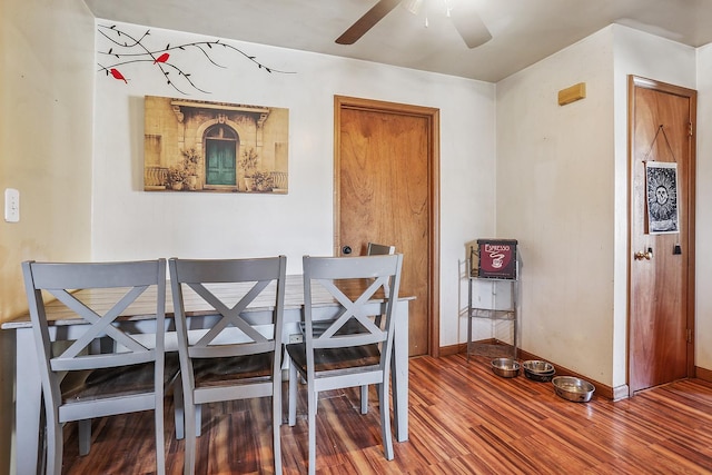 dining area featuring baseboards, a ceiling fan, and wood finished floors