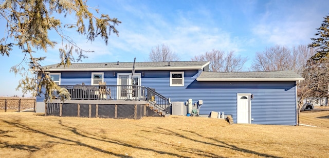 back of property featuring a wooden deck, a lawn, and stairway