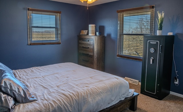 bedroom with visible vents, carpet floors, and baseboards