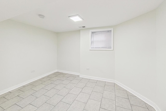 spare room featuring visible vents and baseboards