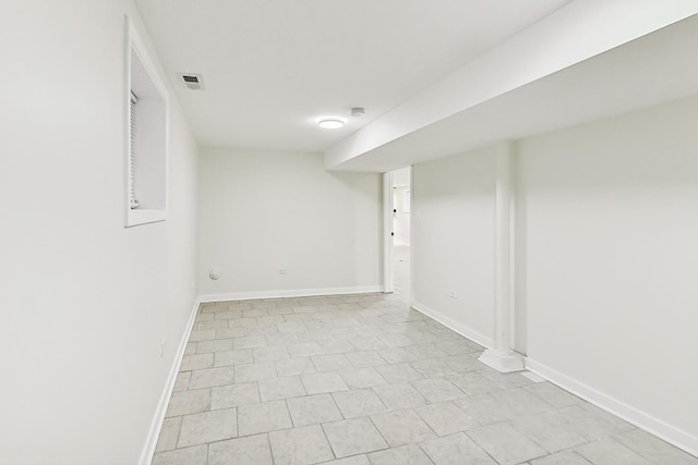 finished basement featuring baseboards and visible vents