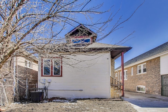 view of side of home with central air condition unit