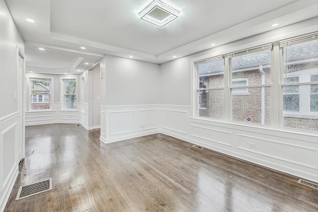 empty room featuring recessed lighting, visible vents, and wood finished floors