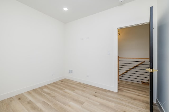 spare room featuring recessed lighting, visible vents, baseboards, and wood finished floors