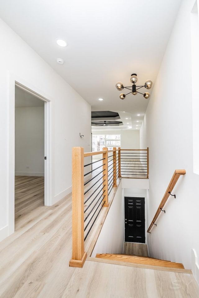 staircase with recessed lighting, baseboards, and wood finished floors