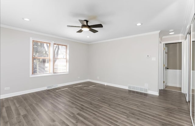 spare room featuring visible vents, crown molding, and dark wood-style flooring