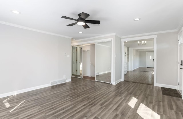 unfurnished room featuring visible vents, ornamental molding, baseboards, and wood finished floors