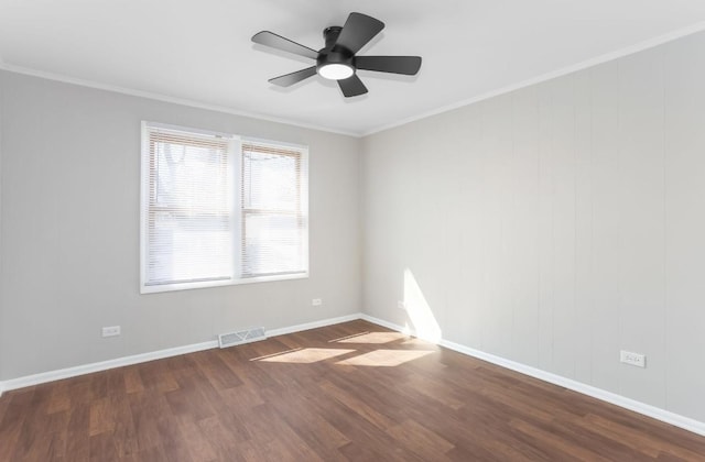 spare room featuring visible vents, baseboards, dark wood-style flooring, and crown molding