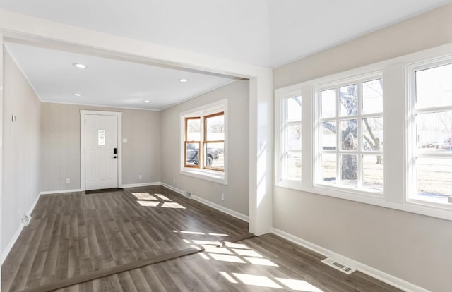 entrance foyer with baseboards, visible vents, recessed lighting, dark wood-style flooring, and ornamental molding