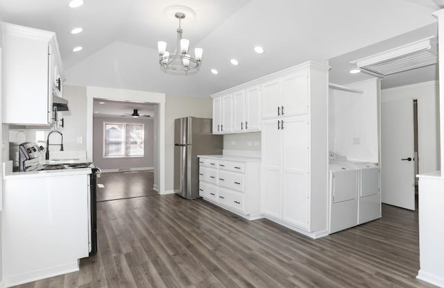 kitchen featuring light countertops, freestanding refrigerator, electric range, white cabinets, and separate washer and dryer