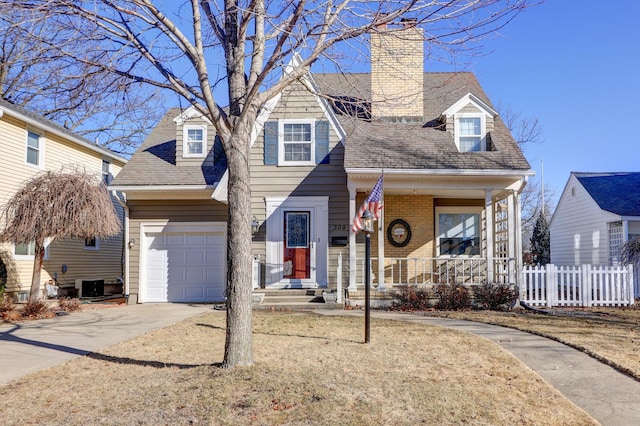 view of front of house featuring driveway, fence, covered porch, an attached garage, and brick siding