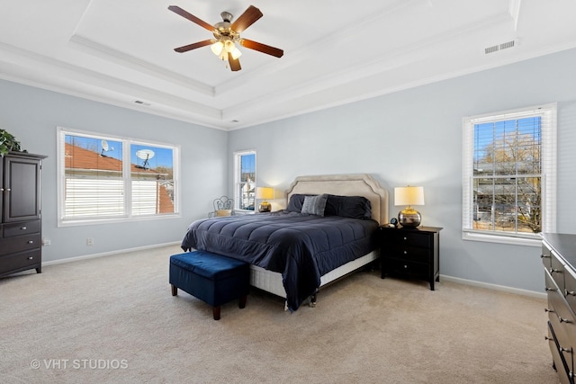 bedroom featuring a raised ceiling, light colored carpet, and crown molding