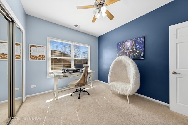 office space with visible vents, baseboards, ceiling fan, and carpet floors