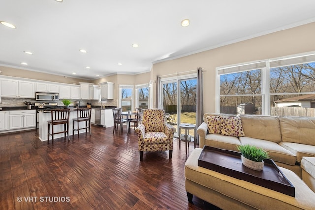 living room featuring dark wood finished floors, recessed lighting, and crown molding