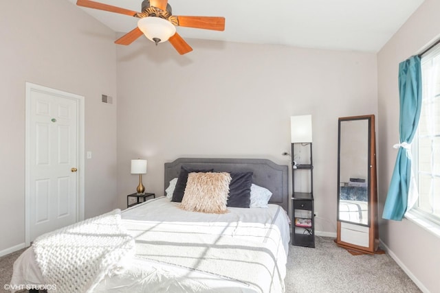 carpeted bedroom with high vaulted ceiling, baseboards, visible vents, and ceiling fan