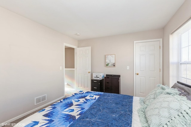 bedroom with baseboards and visible vents