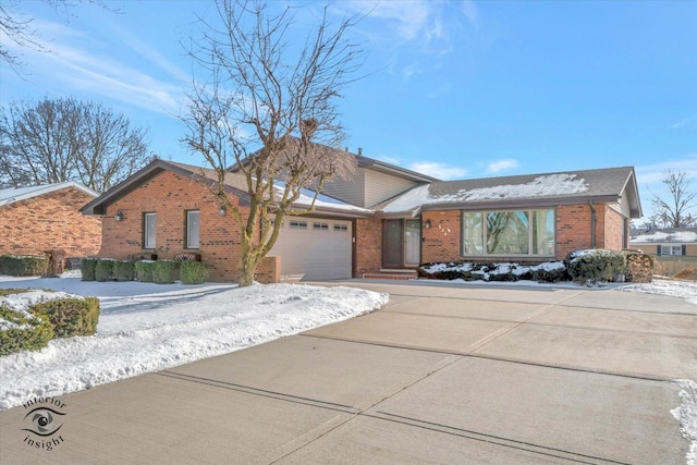 view of front facade with concrete driveway, a garage, and brick siding