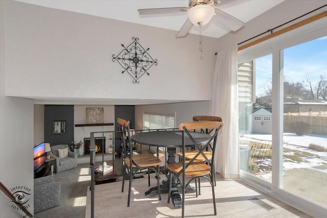 dining room with visible vents, ceiling fan, and wood finished floors